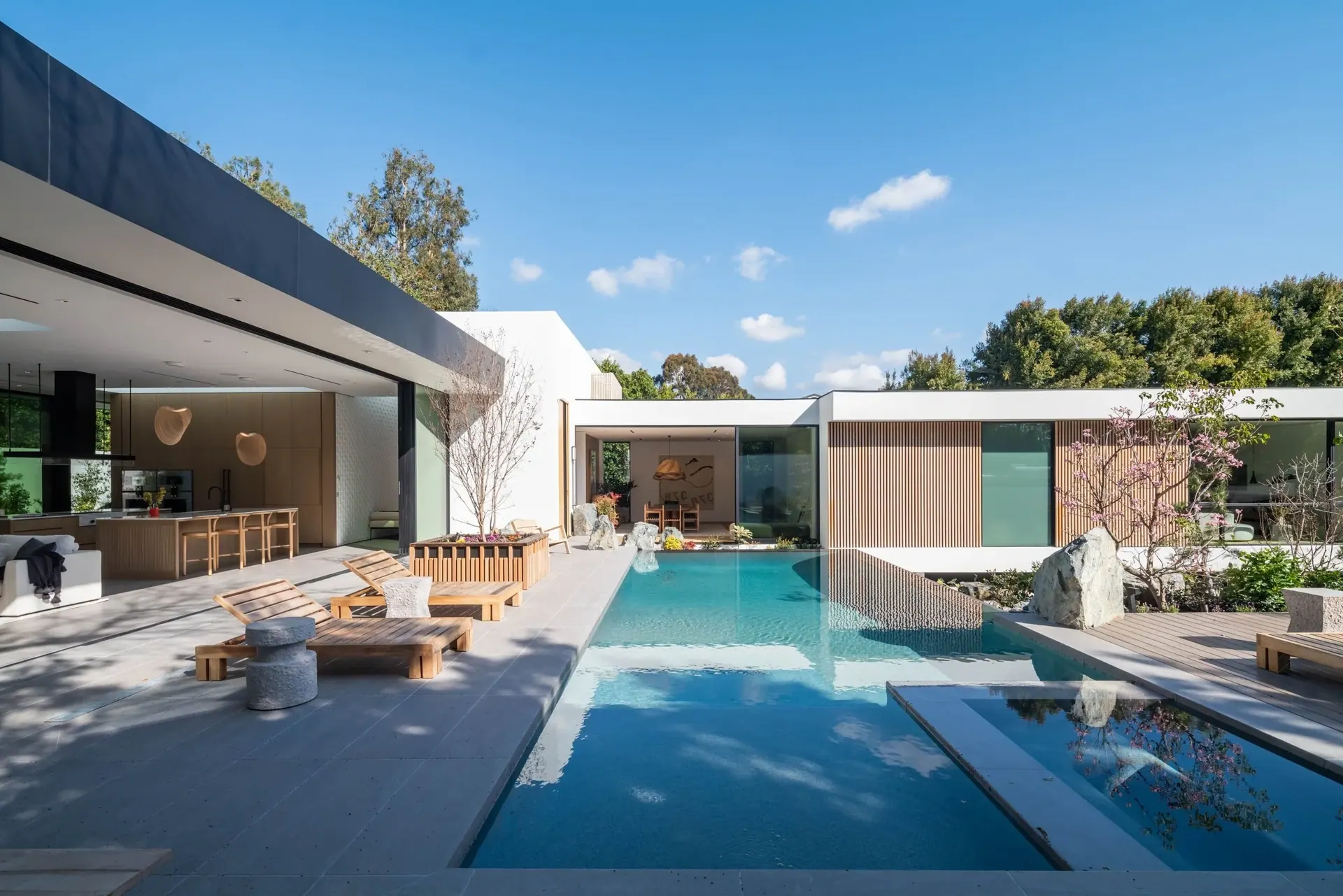 Brentwood — sunlit pool courtyard, warm wood and open glass walls